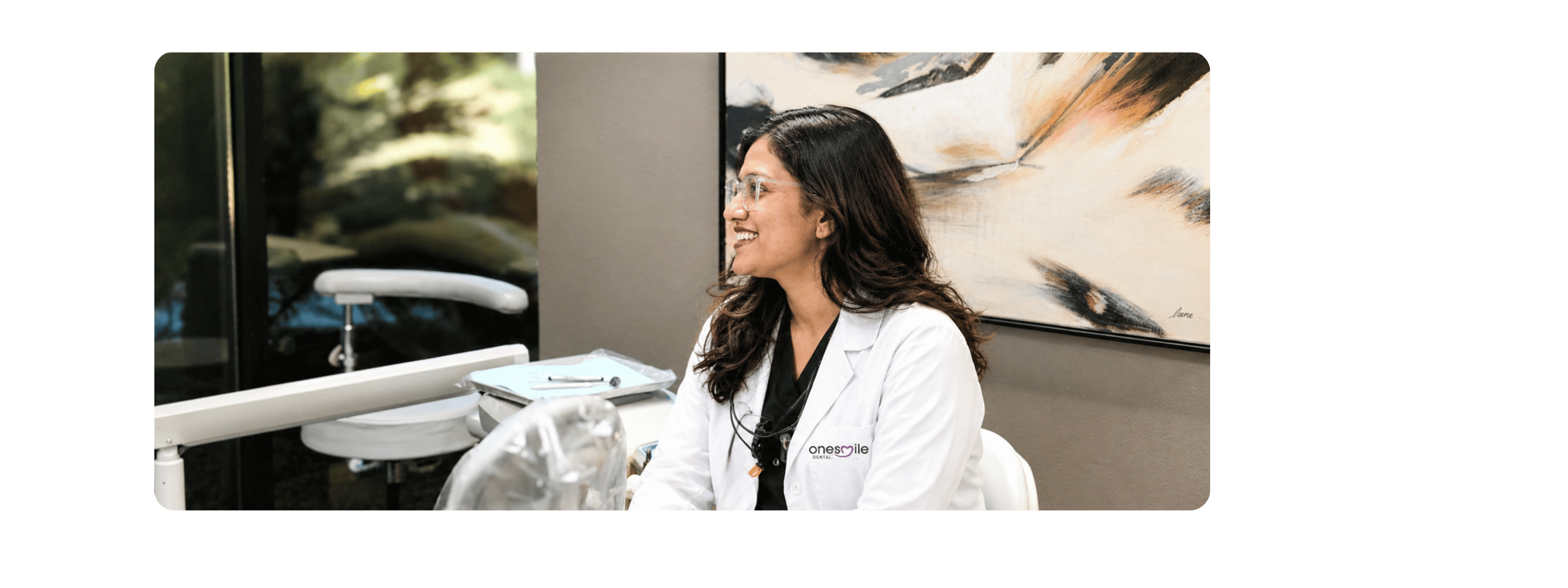 Dr. Vishnuja smiling with a patient in the treatment chair at onesmile Dental Care